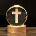 White crystal lamp with 6cm diameter orb on solid wood warm light base showing religious ornamentation