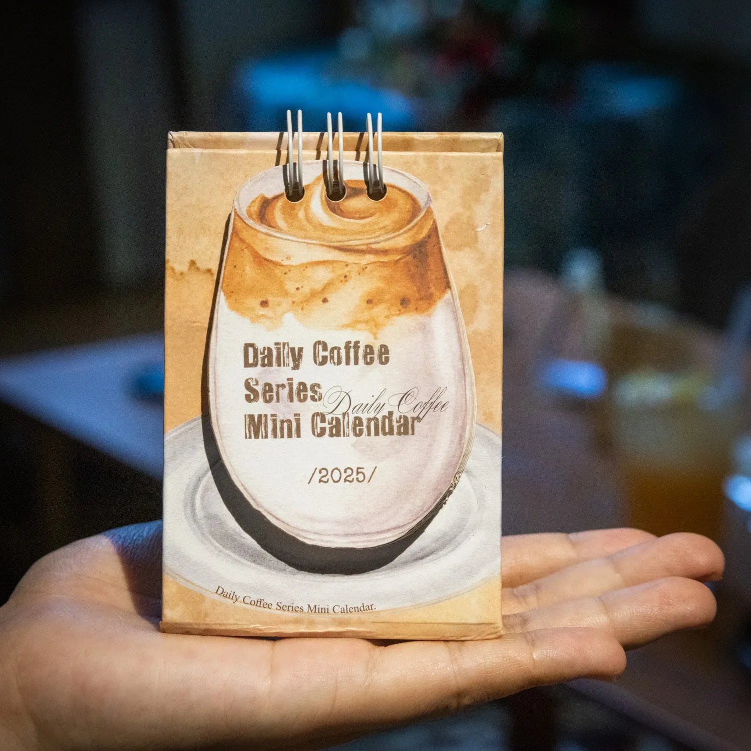 Mini coffee-themed desk calendar for 2025 showing daily pages and simple modern design