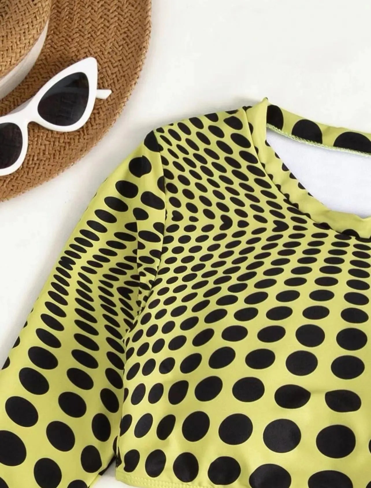 Green and yellow polka dot women's swimsuit three-piece set with top, skirt, and bra.