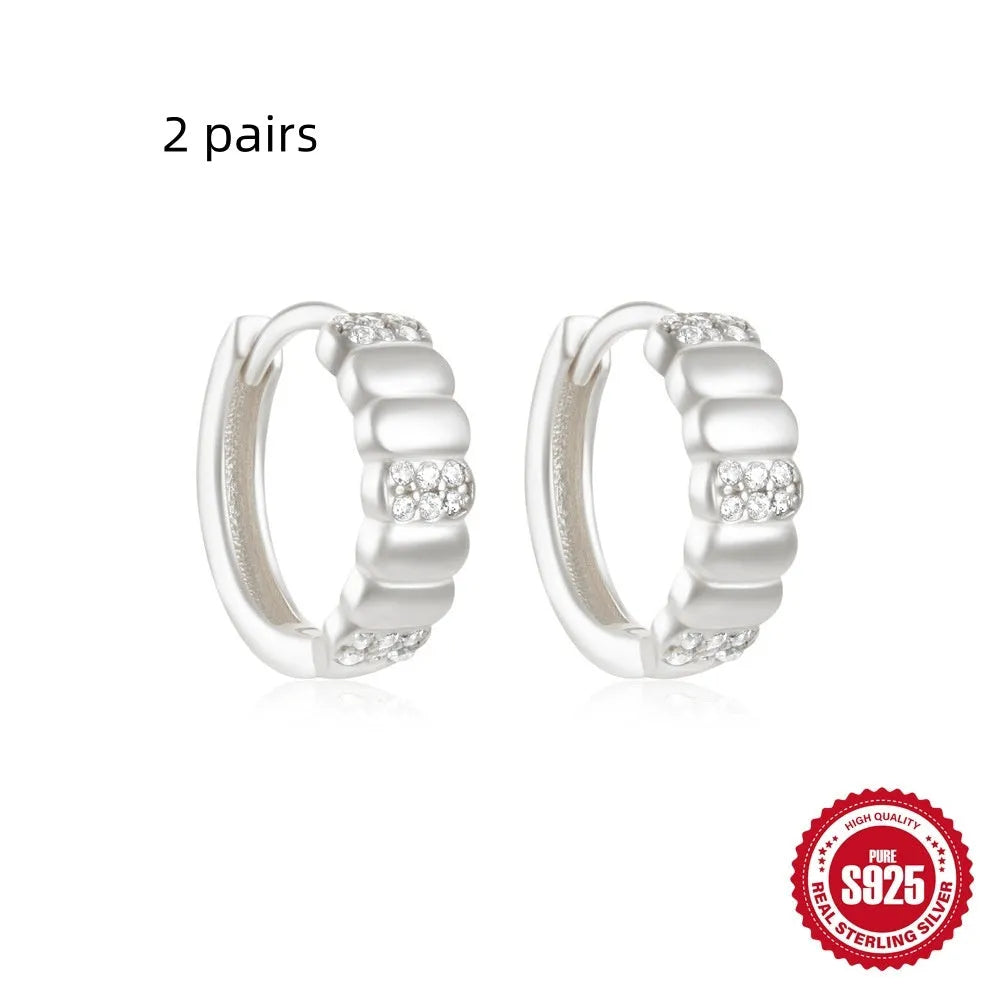 Small round geometric sterling silver stud earrings with a diamond shape, available in gold or silver finish.