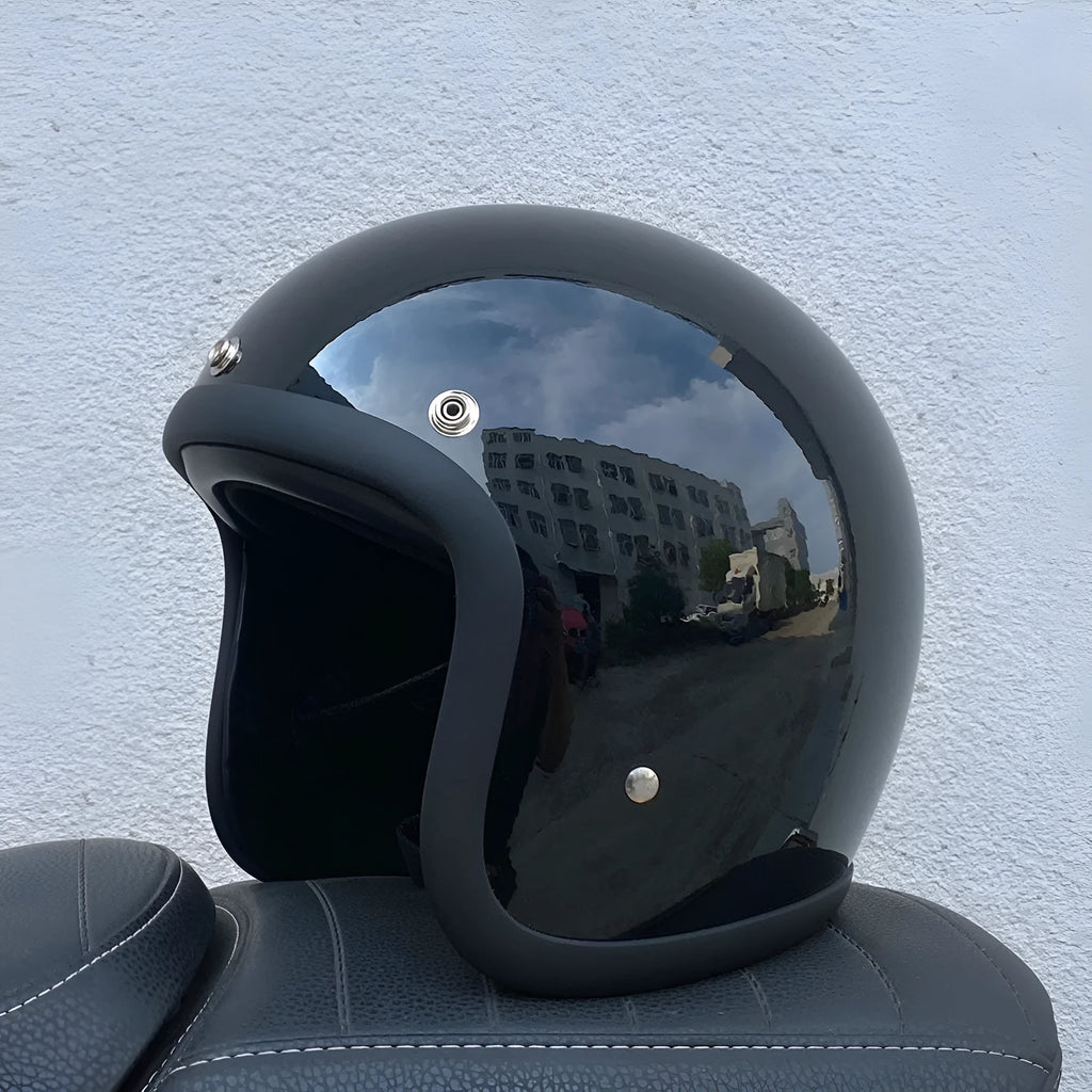 Glass fibre retro half motorcycle helmet shown in multiple colour options including cement grey and matte black flower patterns