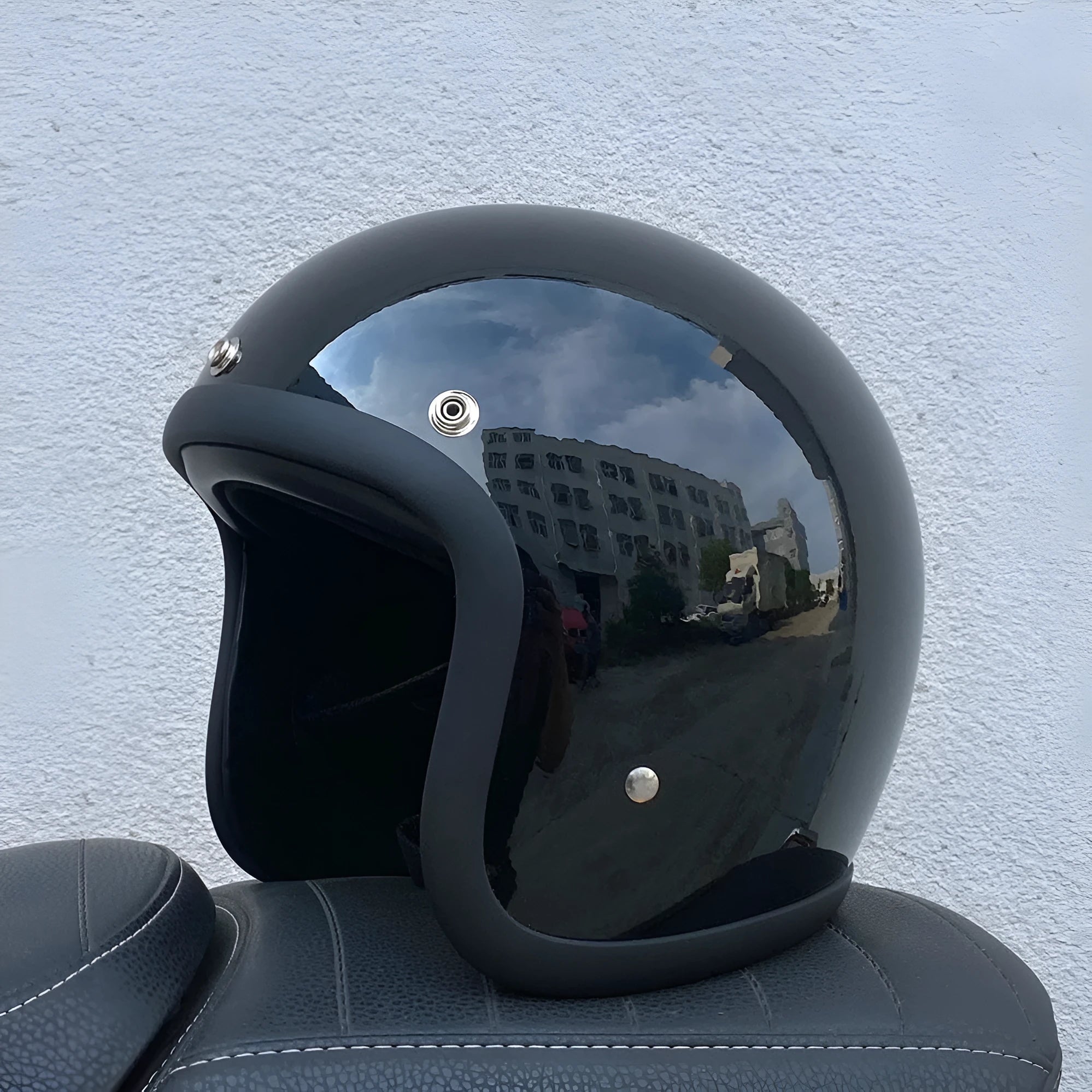 Glass fibre retro half motorcycle helmet shown in multiple colour options including cement grey and matte black flower patterns