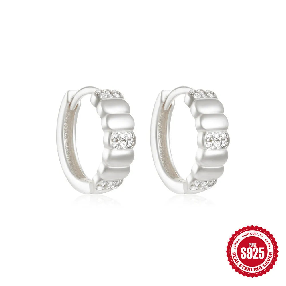 Small round geometric sterling silver stud earrings with a diamond shape, available in gold or silver finish.