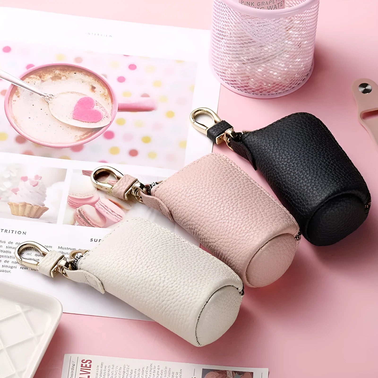 Simple black PU zipper key ring case for car and home keys on a grey background.