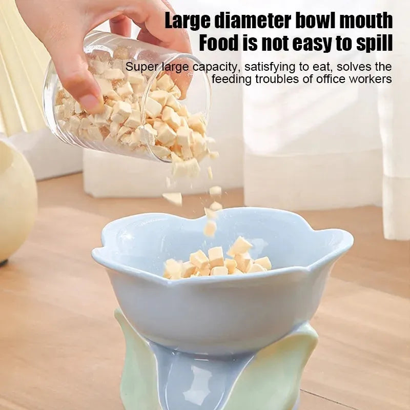 Blue ceramic elevated pet bowl with floral pattern and non-slip base for cats or small dogs.