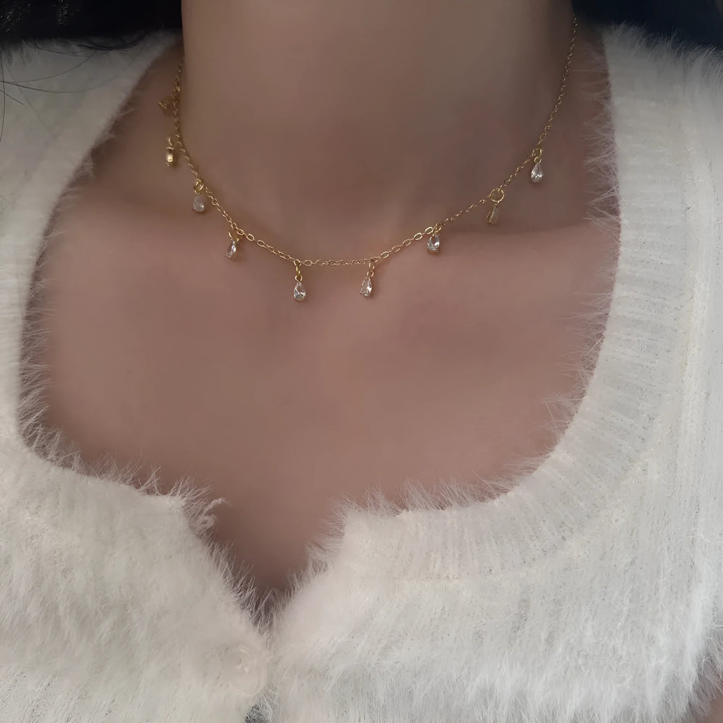 Women's zircon jewellery set showing geometric necklace, matching earrings, and anklet with meteor shower design.
