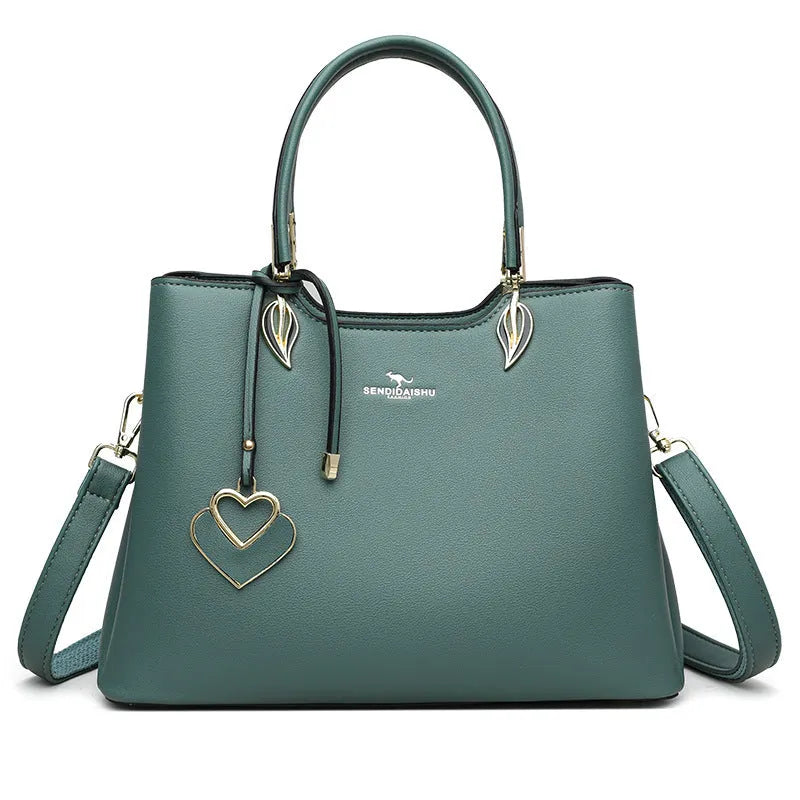 Women's black PU messenger bag with multi-layer design and visible sewing thread detail.