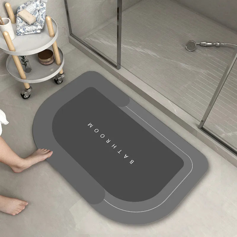 Soft blue oval bathroom floor mat placed on tiles beside a bathtub.