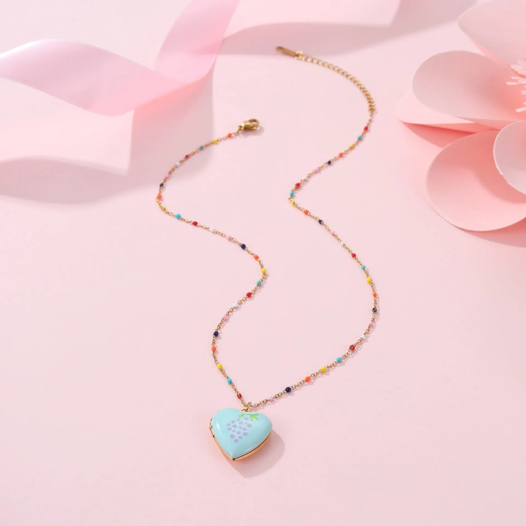 Women's stainless steel necklace with gold plating showing heart-shaped fruit pendant design on adjustable chain