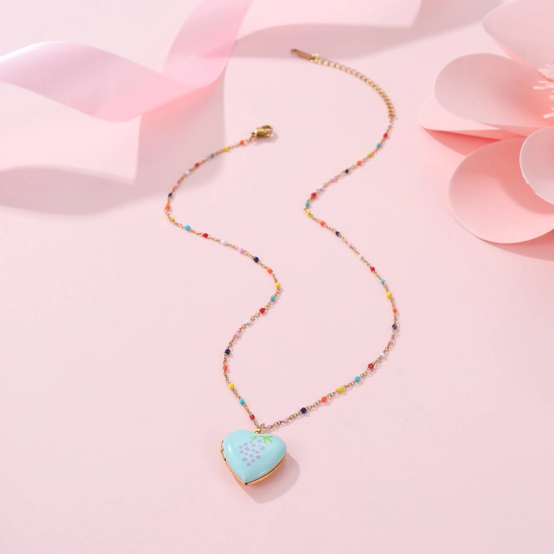 Women's stainless steel necklace with gold plating showing heart-shaped fruit pendant design on adjustable chain