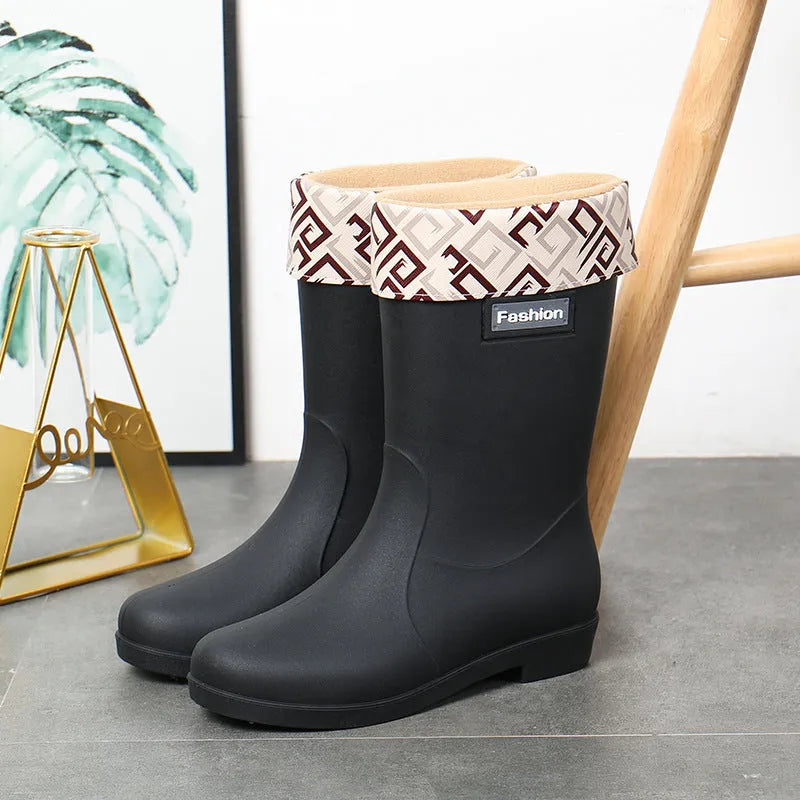Women's black PVC rain boots with mid-calf height and low heel