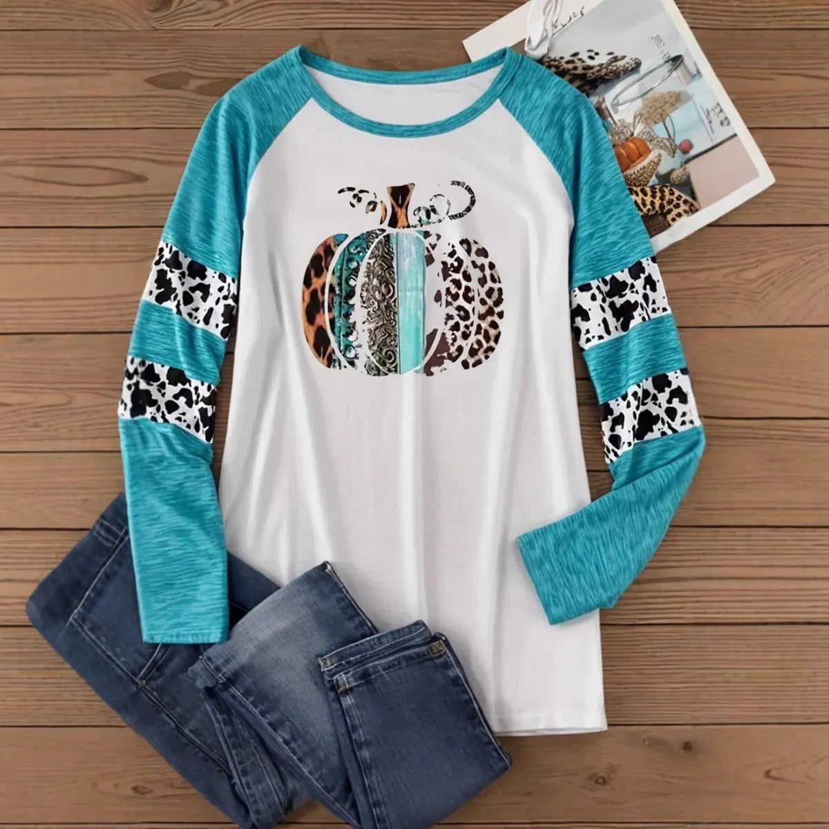 Sky blue Halloween t-shirt featuring a large white 3D digitally printed pumpkin design on the front.
