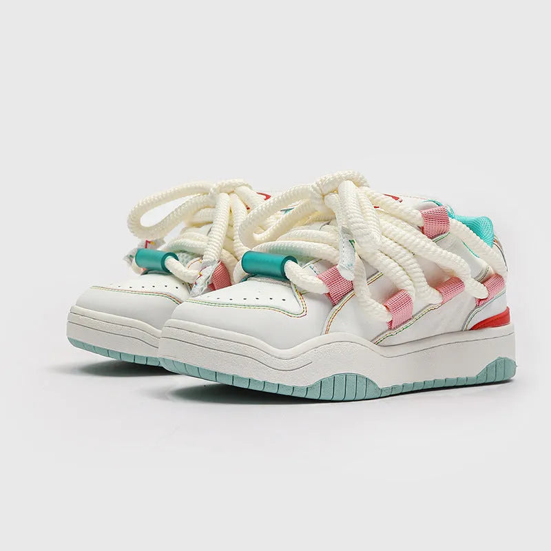 Pair of thick-soled casual lace-up shoes in a solid colour on a white background.