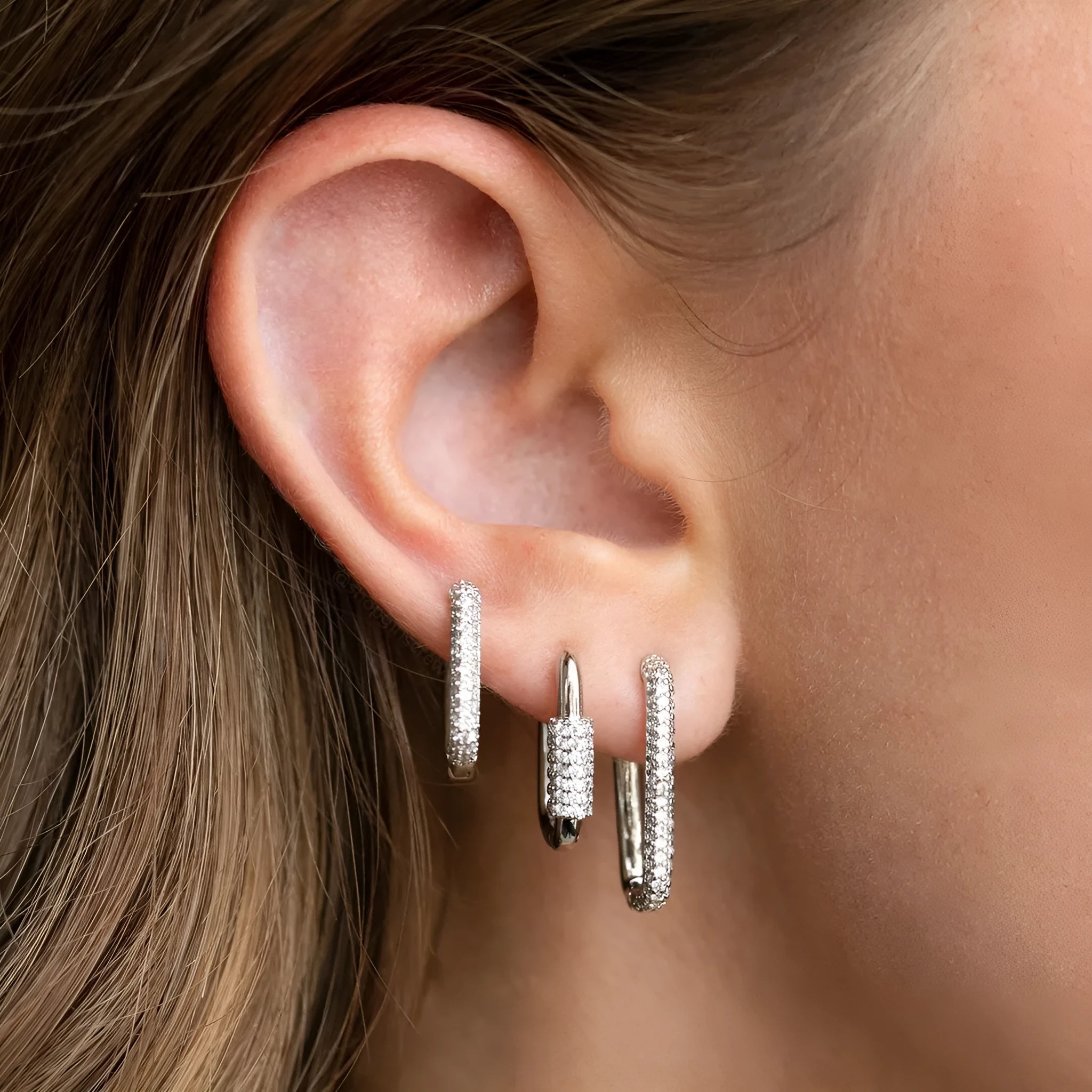Three geometric copper earrings with zircon micro inlay in clip-on design showing ellipse and quadrilateral shapes
