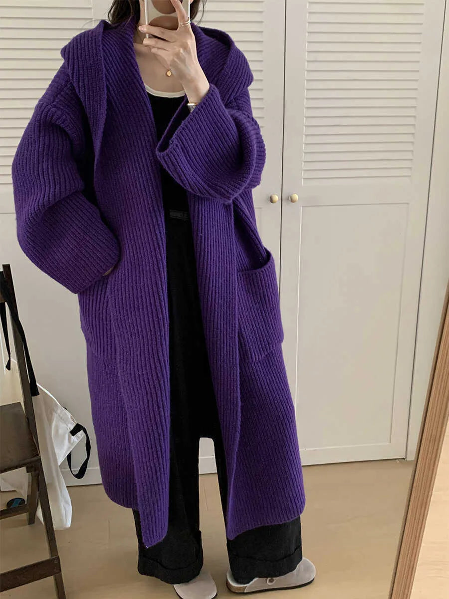 Loose hooded acrylic cardigan coat for women in beige, showing long length and raglan sleeves.