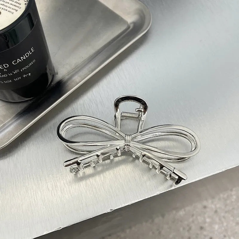 Korean style bow barrette with alloy metal construction in silver colour