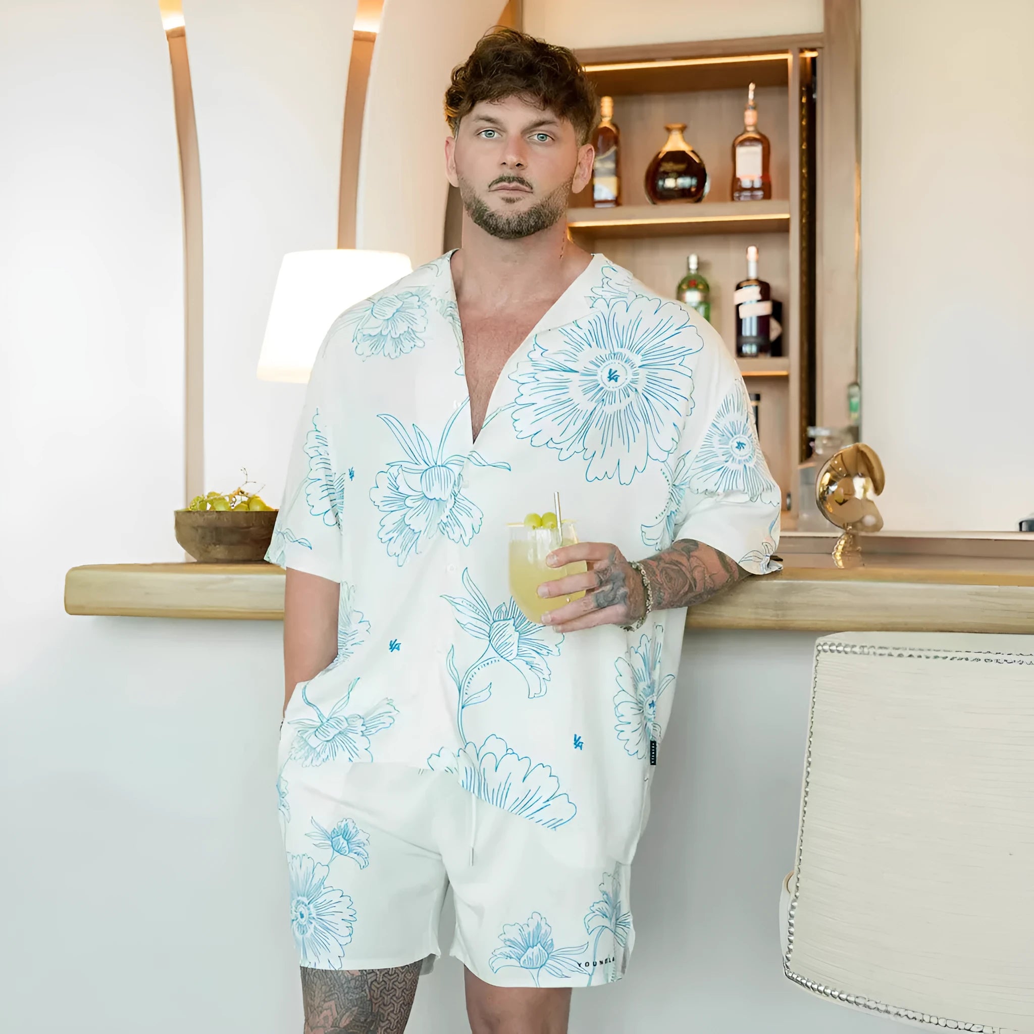 Men's loose fitting short sleeve top with floral print pattern in lightweight polyester fabric