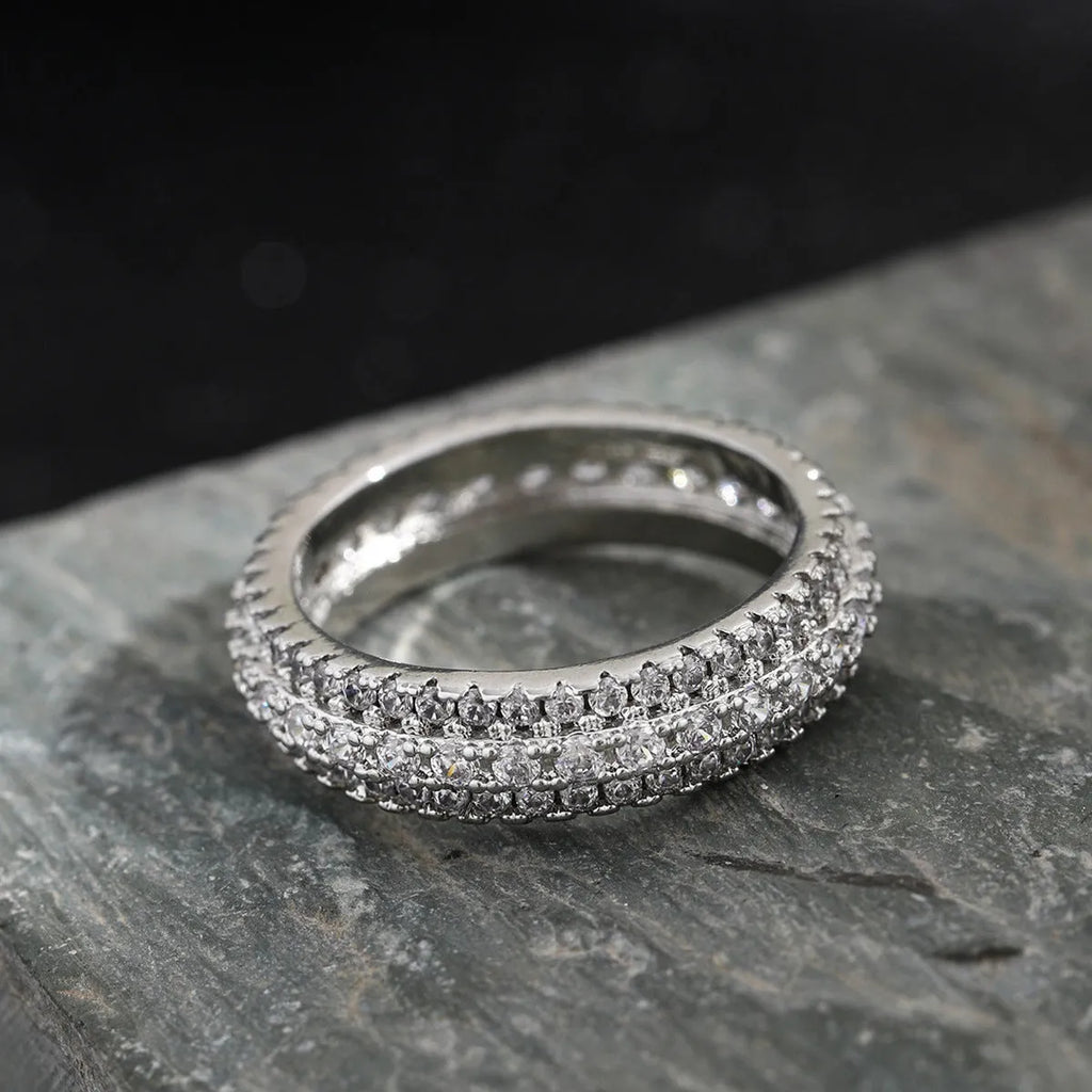 Geometric copper ring with triangular zircon stone, shown in white gold, yellow gold, and white and black finish options.
