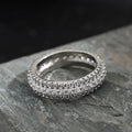 Geometric copper ring with triangular zircon stone, shown in white gold, yellow gold, and white and black finish options.