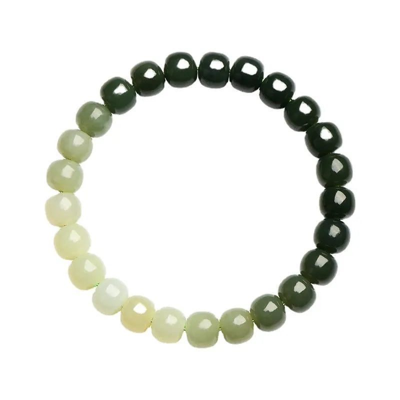 Natural Hetian jade bracelet with gradient clear water coloured beads on a wrist.