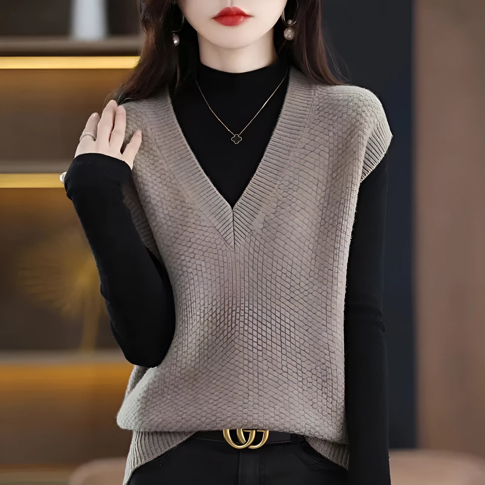 Cashmere acrylic knitted sleeveless V-neck vest with a raised 3D pattern, shown in creamy-white colour.