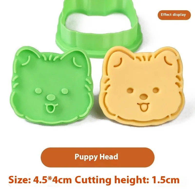 Three dimensional plastic biscuit mould showing puppy cartoon designs including birthday hats and swimming rings