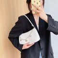 Butterfly chain crossbody bag in PU leather with a retro style, shown in light blue.