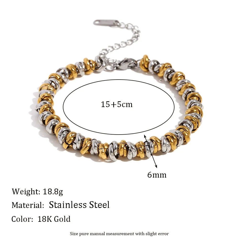 Gold electroplated geometric jewellery set with earrings, bracelet, and necklace on stainless steel