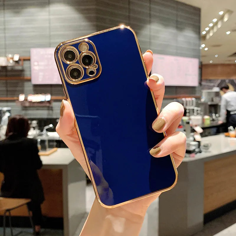 Cartoon style iPhone case with a gold plated cover and silicone stripe accents on a solid coloured TPU background.