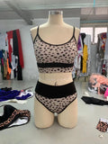 Women's white and leopard print high-waist bikini swimsuit set on a mannequin.