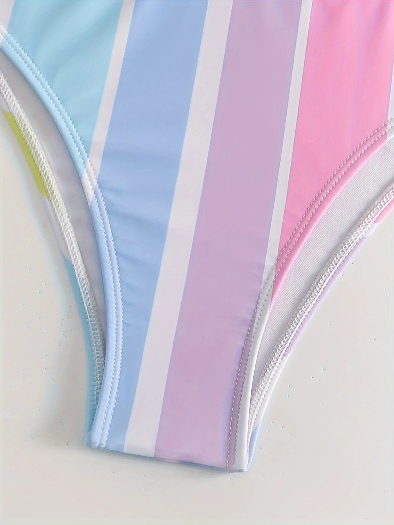 Women's striped blue and white sports bikini set on a mannequin