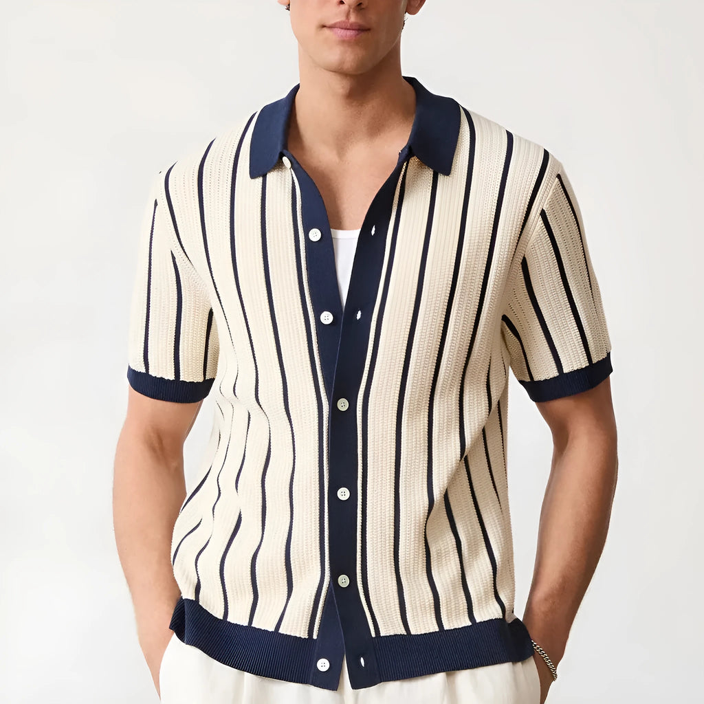 Men's white short sleeve knitted shirt with an asymmetric lapel, laid flat.