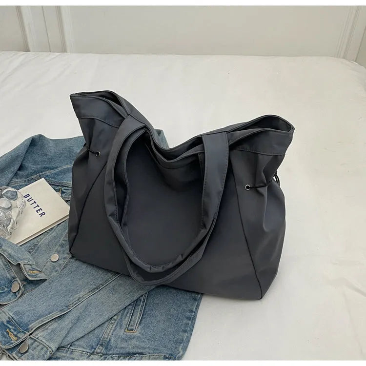 Soft Oxford cloth foldable commuter tote bag in street style, shown in multiple colour options.