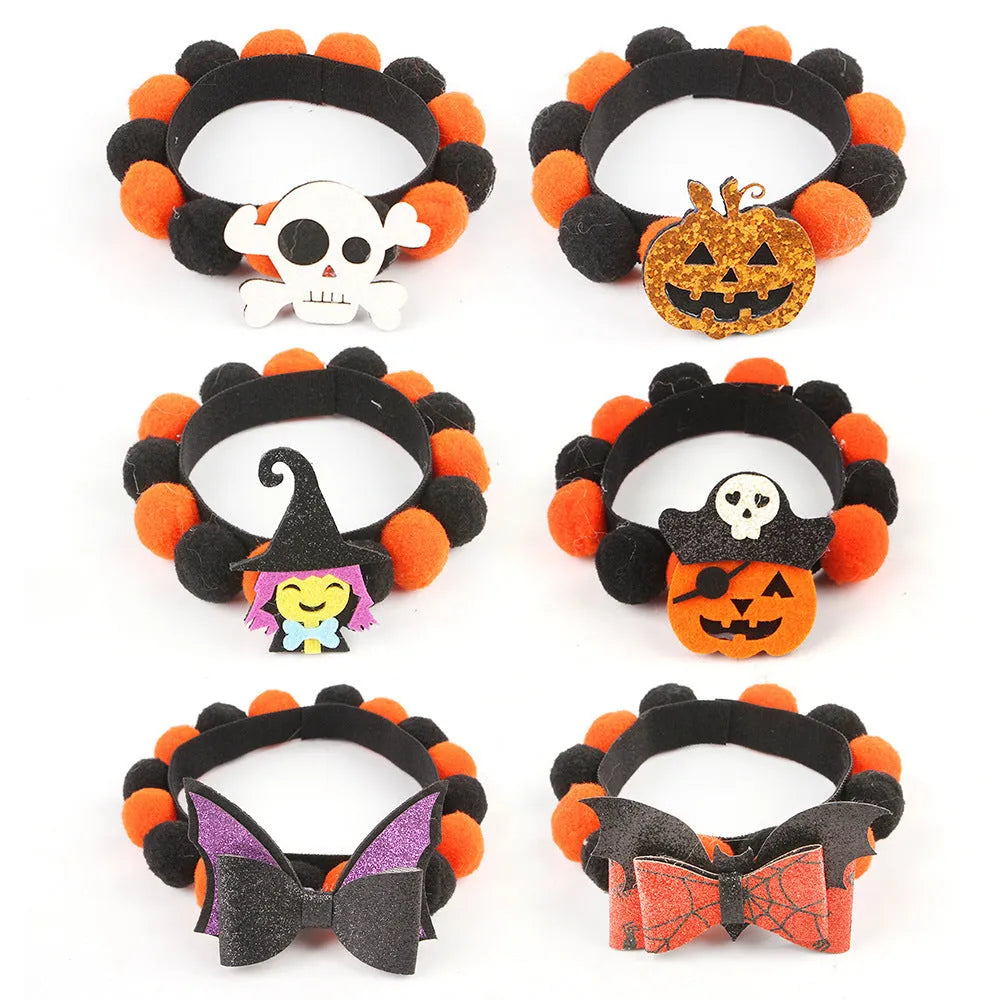 Halloween dog collar with a large orange pom-pom and pumpkin design on an adjustable black band.
