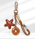Handmade brown polymer clay soda bread charm on a brown strap, showing cartoon bread design details.