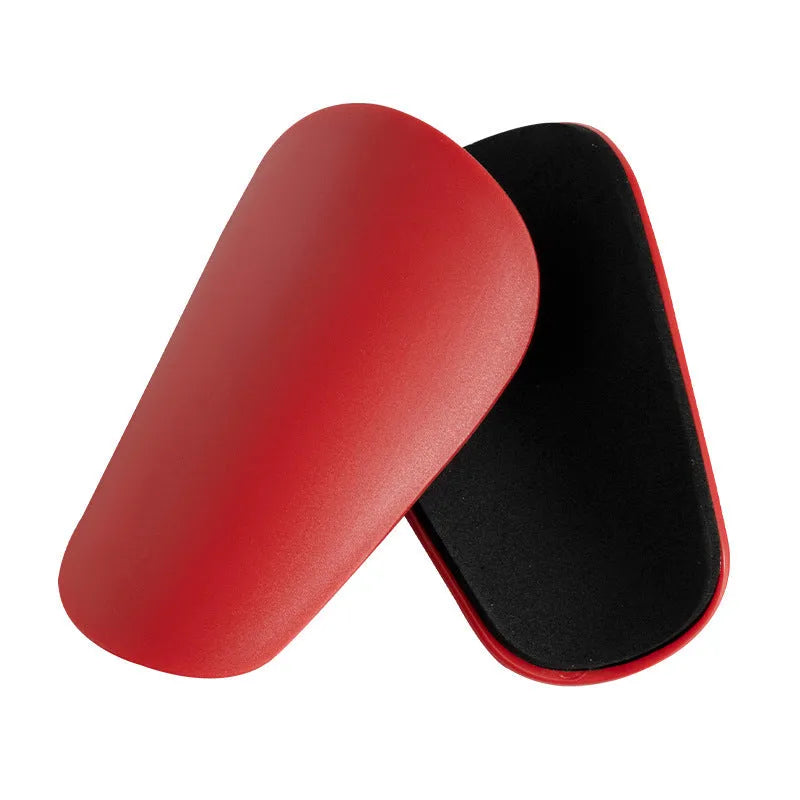 PU mini shin guards for football and sports protection in black, white, red, and blue colours.