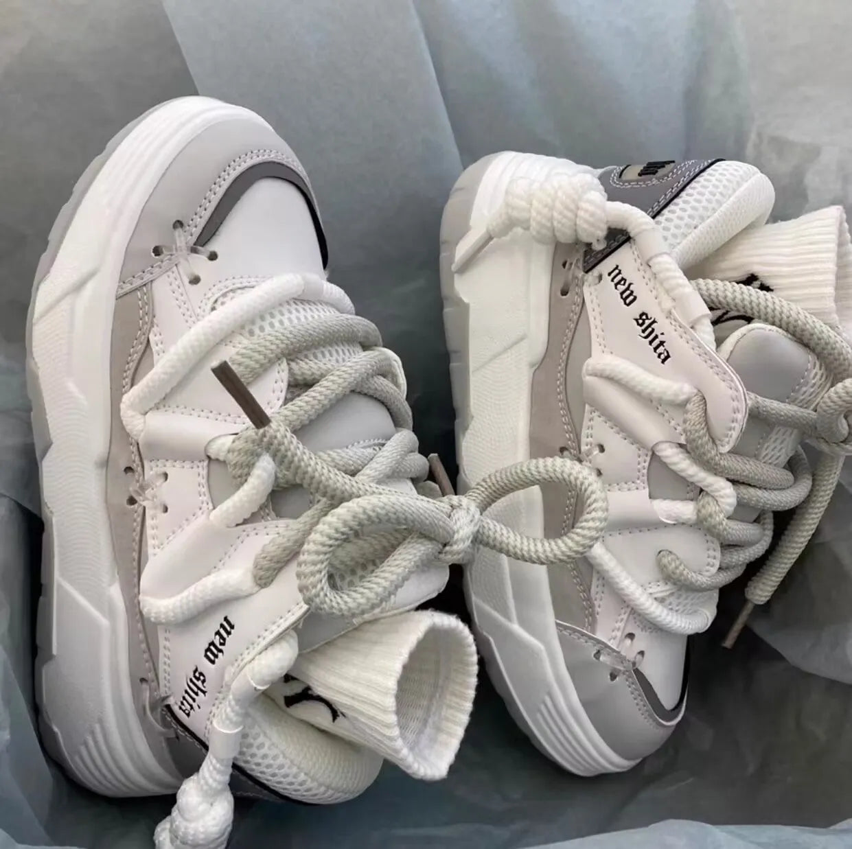 Women's grey retro platform sneakers with thick rubber sole and front lace-up closure
