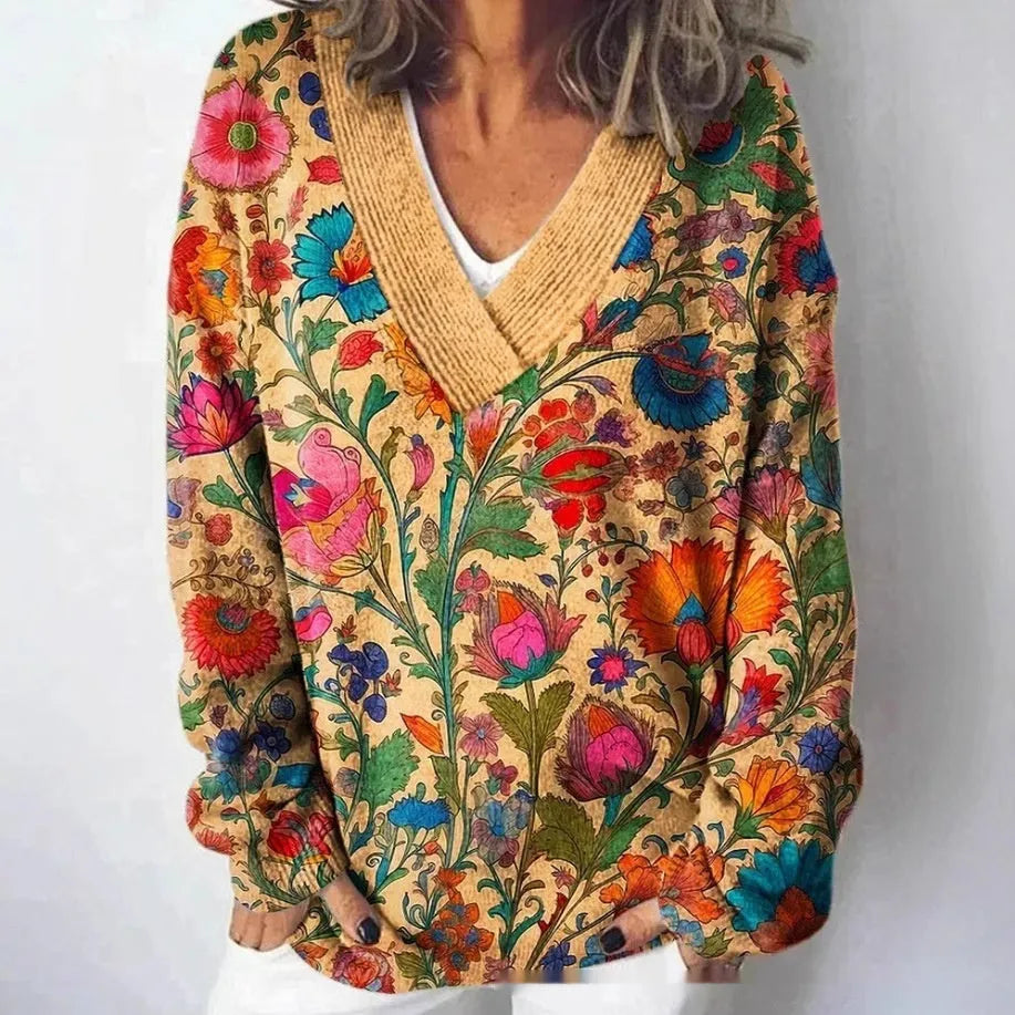 Women's white floral print V-neck sweatshirt with 3D pattern and long sleeves on a hanger.