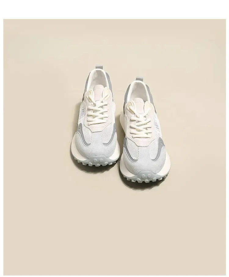 Women's grey and pink retro sneakers with mesh lining, rubber sole, and round toe design