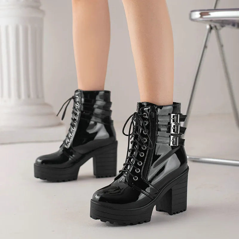 Women's black ankle boots with thick heel, round toe, and front lace-up on a waterproof platform sole.