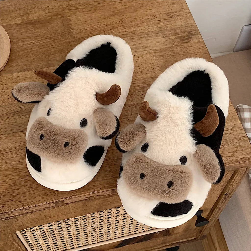 White cow design slippers with plush faux fur upper and textured non-slip sole