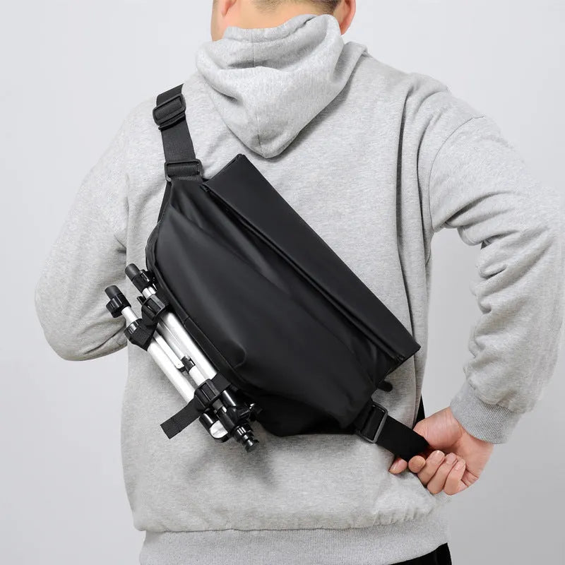 Men's grey crossbody bag showing internal phone pocket and document compartment with shoulder strap