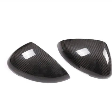 True carbon fibre rearview mirror cover for Porsche Macan, showing black woven pattern.