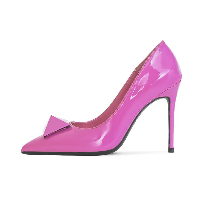 Pink women's pointed toe stiletto high heels with patent leather upper, rivet buckle detail, and a tall thin heel.