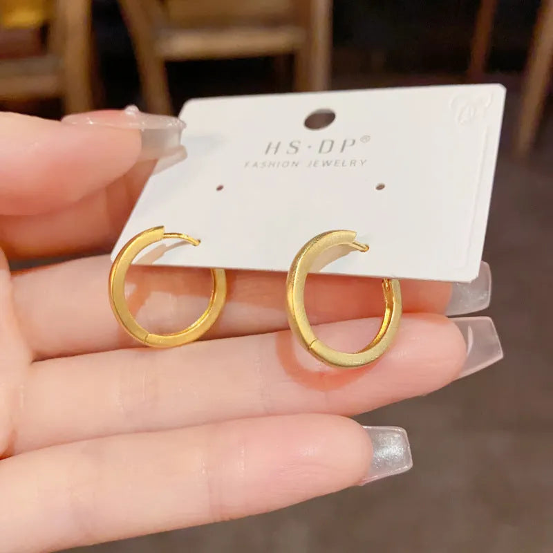 Geometric round ear clip jewellery with gold plating in minimalist style