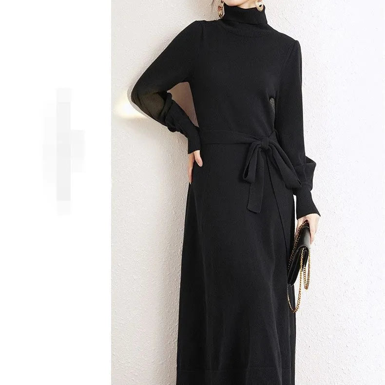 Loose-fitting turtleneck knit dress in rose red with long sleeves and a mid-length skirt.