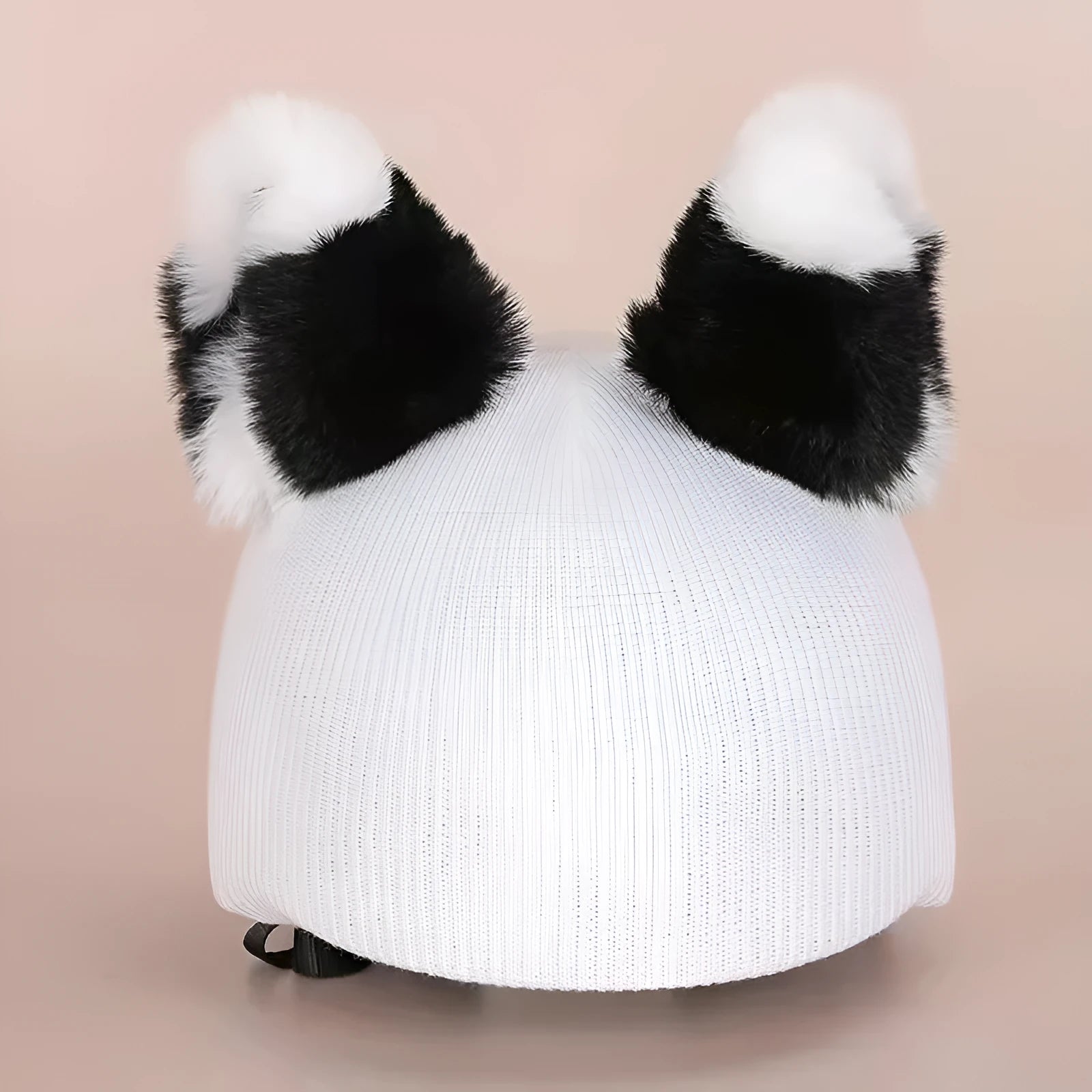 Plush fabric ski helmet decoration with cartoon design on a black ski helmet.