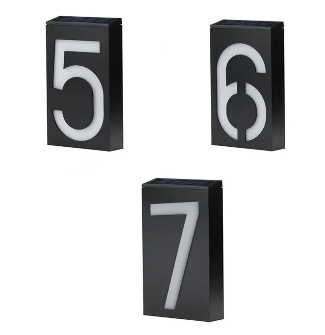 Solar-powered white LED house number light mounted on an outdoor wall