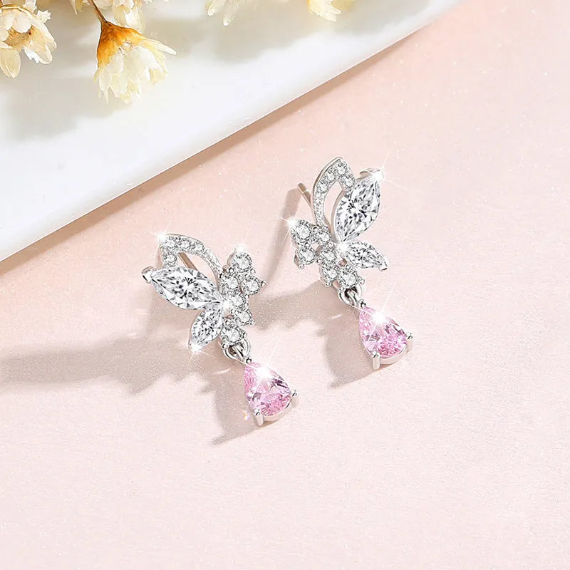 A pair of sterling silver butterfly stud earrings with crystal details on a white background.