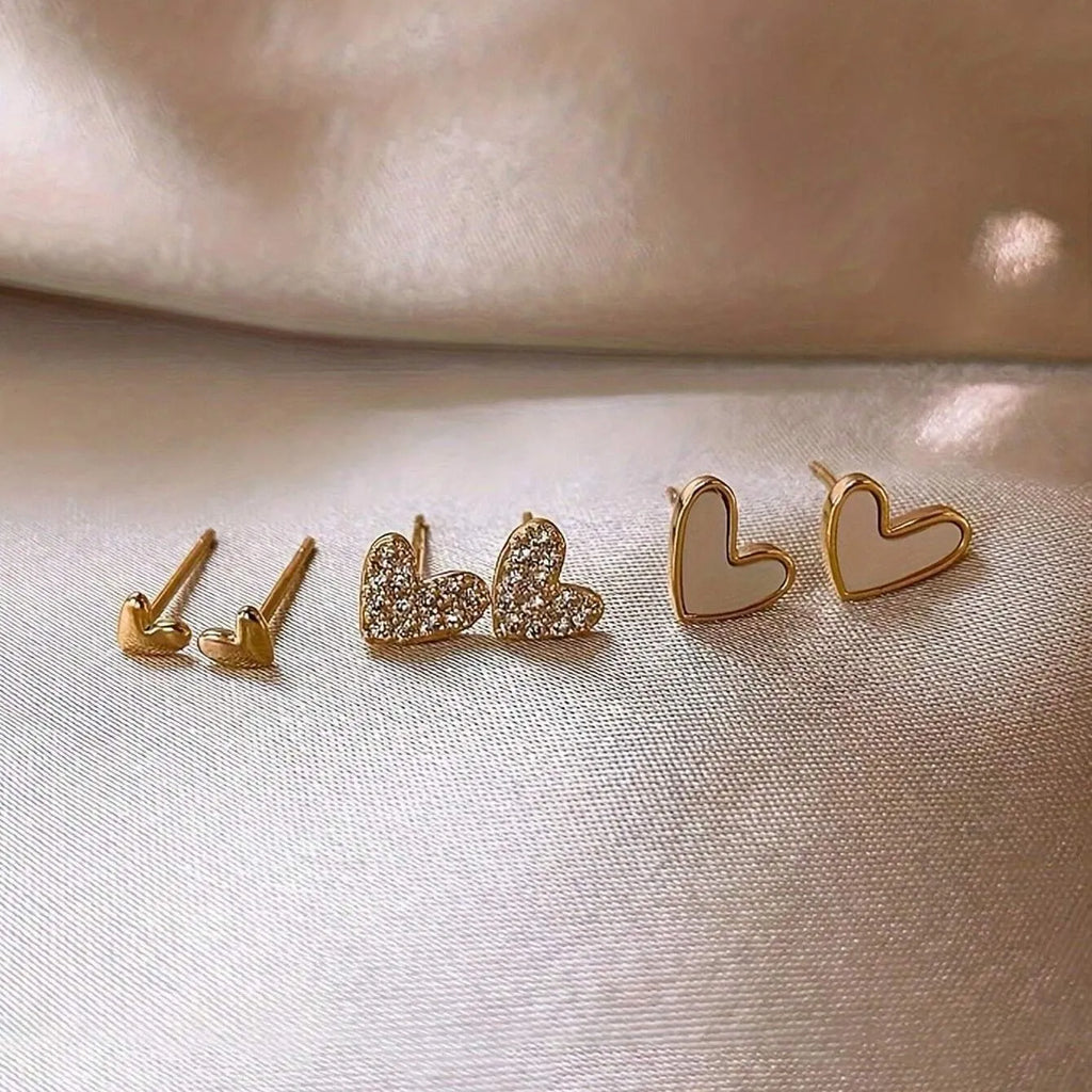 Three pairs of heart-shaped alloy earrings with love motifs in four colour options